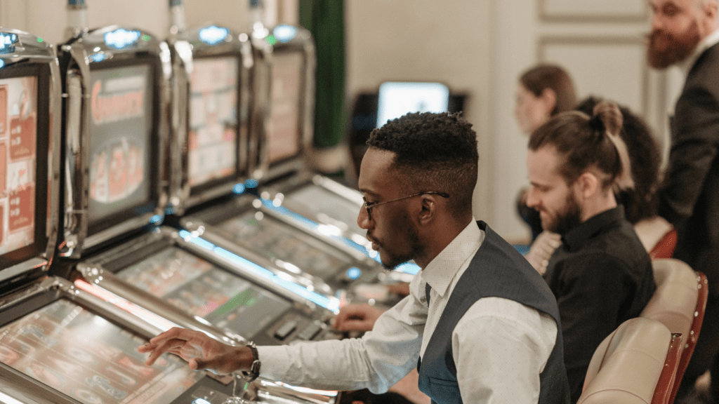 group of people playing casino machine