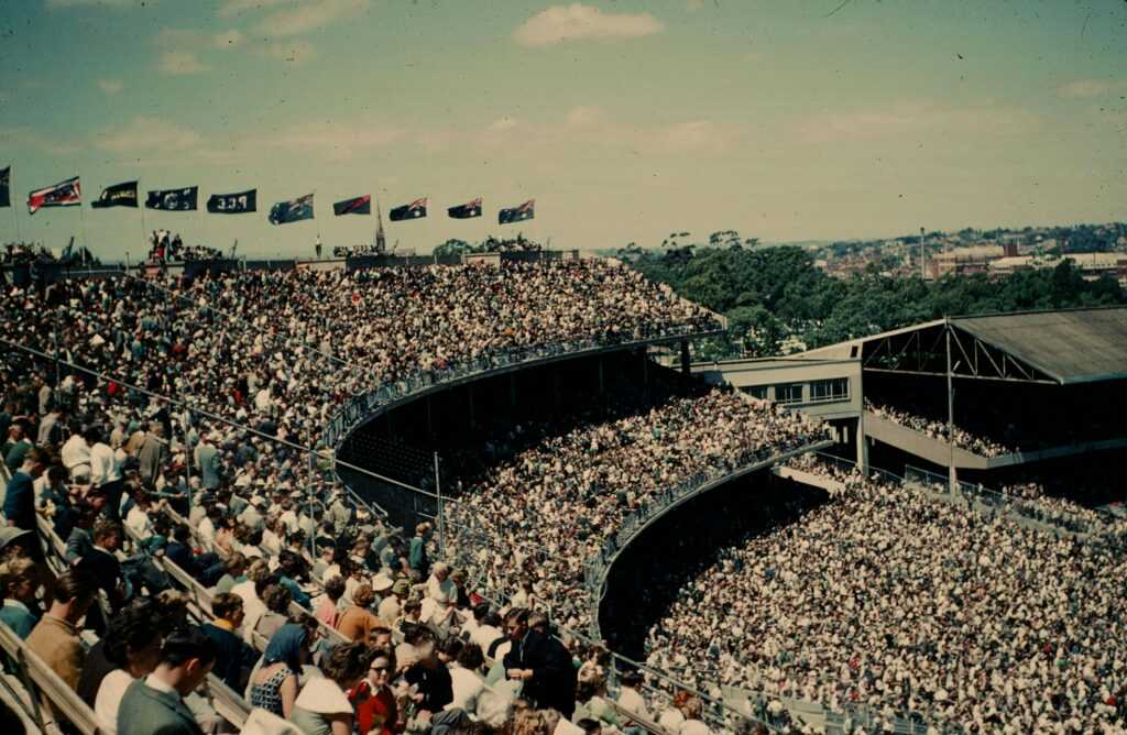 Historic view of a packed crowd at Melbourne Cricket Ground during an AFL match.